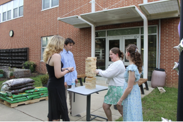 Jenga game time: Participants of the GSA formal gather together to play a fun game of Jenga. The event took place on May 8 in Conestoga’s small courtyard. 